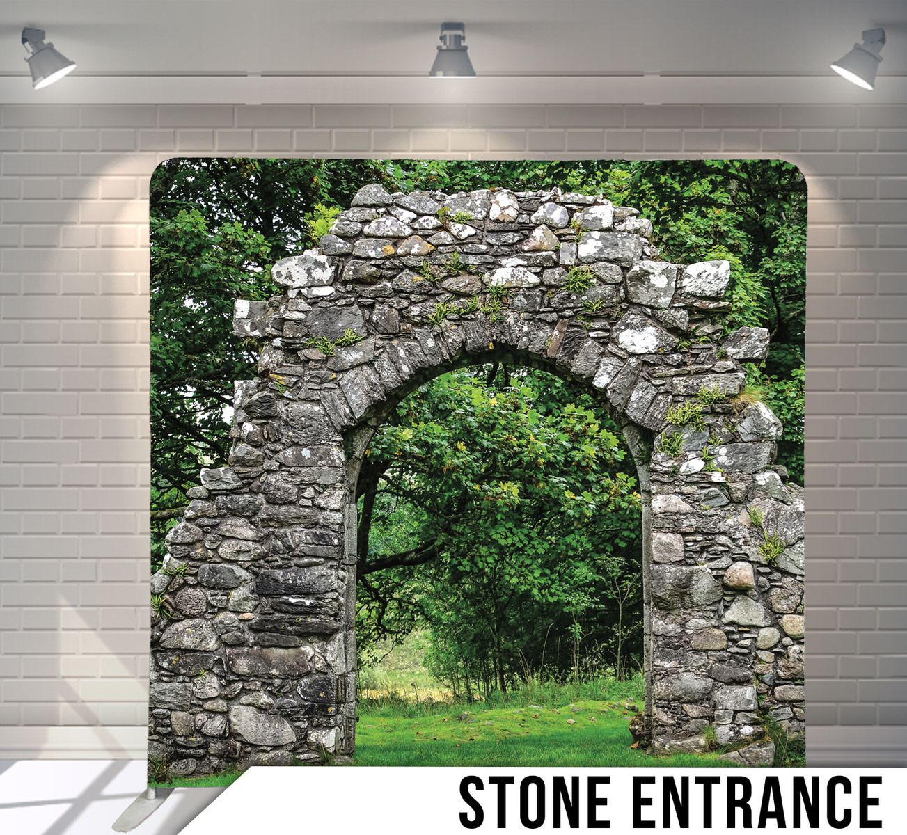 Ancient stone archway entrance covered in moss leading to green garden path.