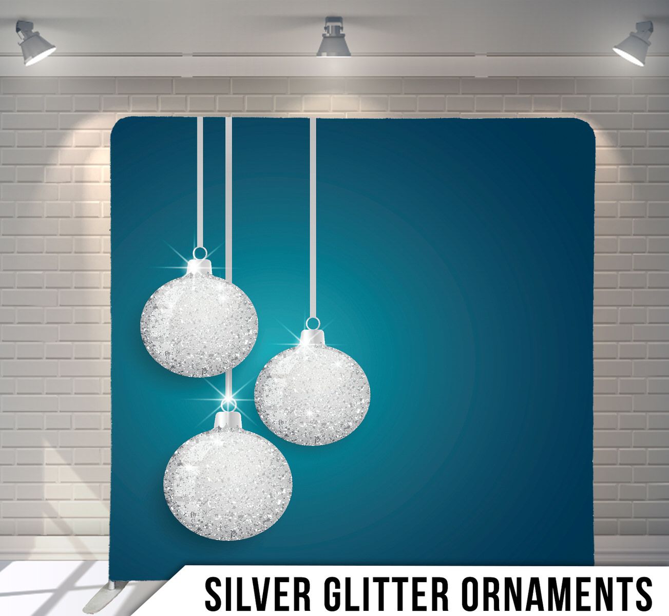 Decorative silver Christmas baubles suspended on strings against turquoise backdrop.