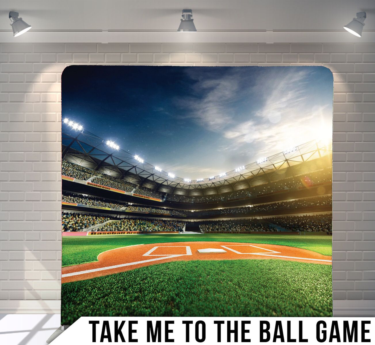 Baseball stadium field at sunset with dramatic sky and bright stadium lights.