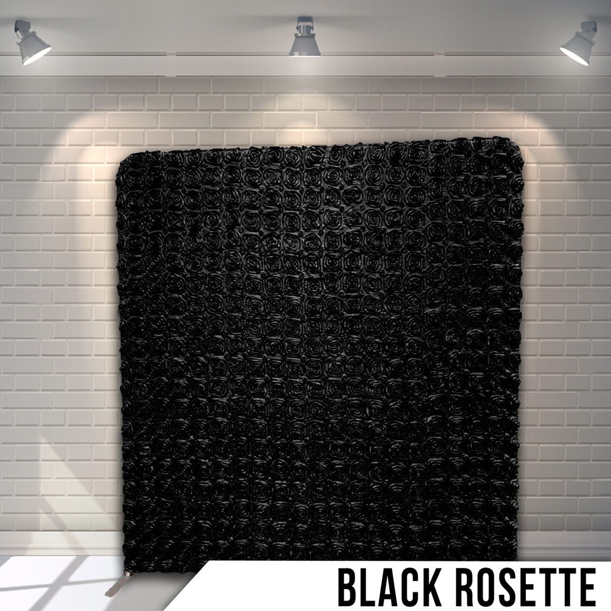 Black textured fabric backdrop with rosette pattern creating dimensional effect.