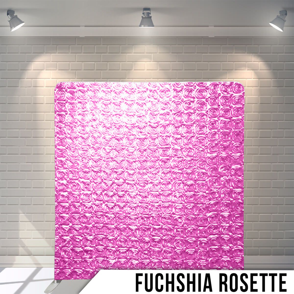 Bright fuchsia pink rosette patterned backdrop displayed against white brick wall with spotlights.