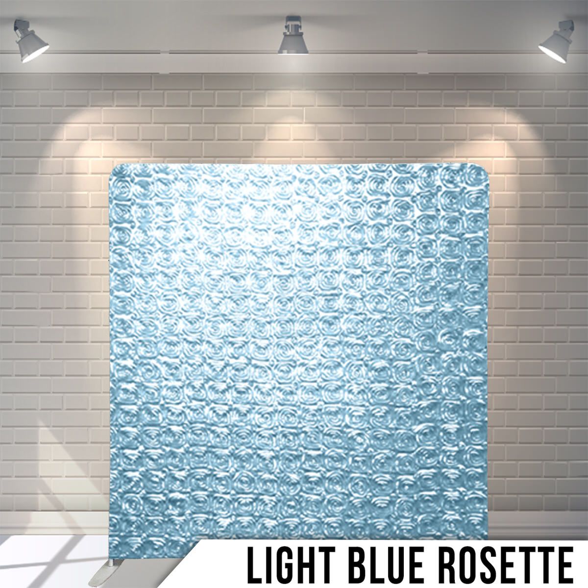 Light blue rosette textured backdrop display with decorative fabric pattern under overhead lighting.