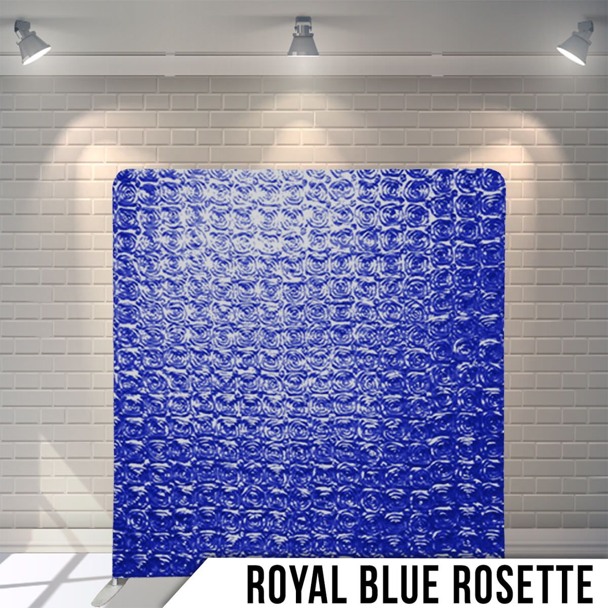 Royal blue rosette textured fabric backdrop illuminated by dramatic overhead lighting.
