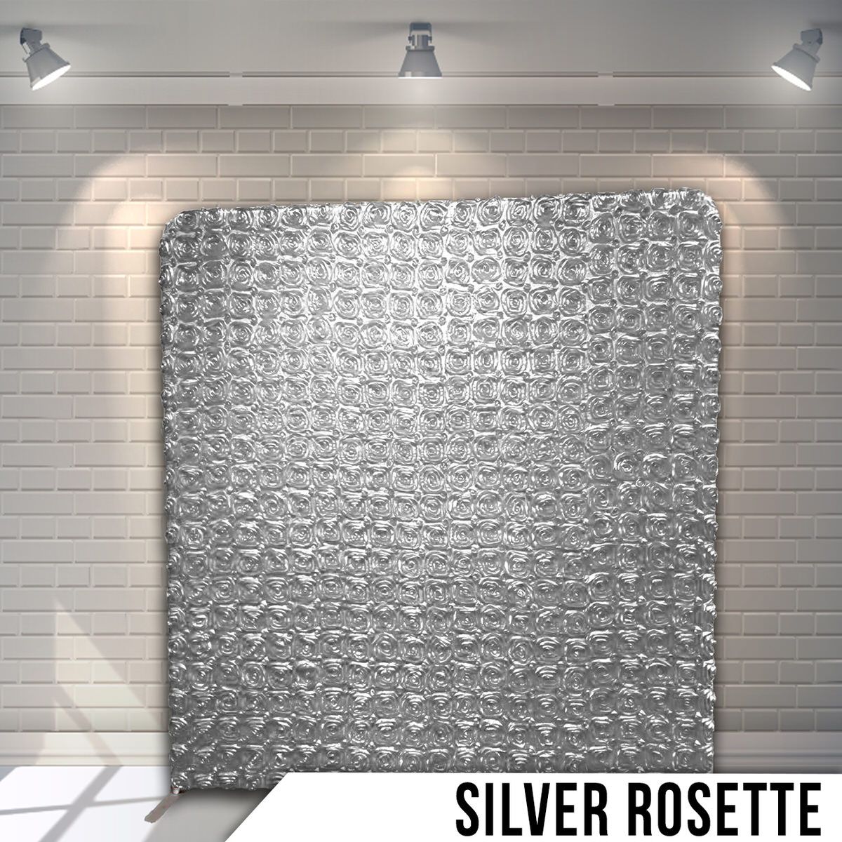 Silver rosette patterned backdrop with elegant textured design lit by overhead spotlights.