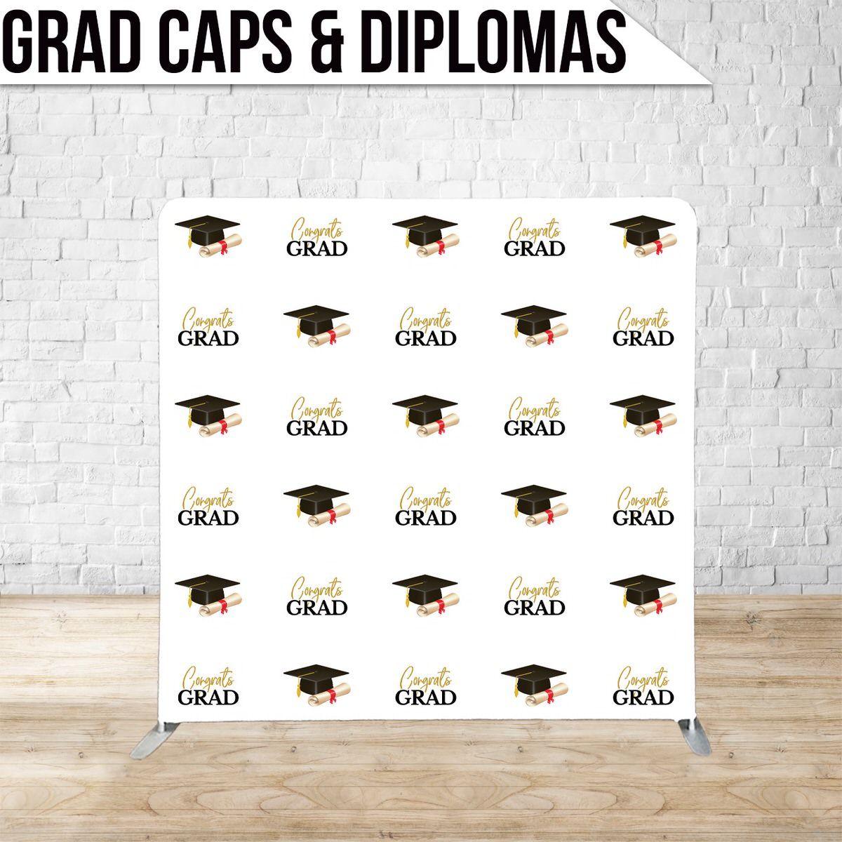 Graduation backdrop display with repeating pattern of black graduation caps and 'GRAD' text on white background.