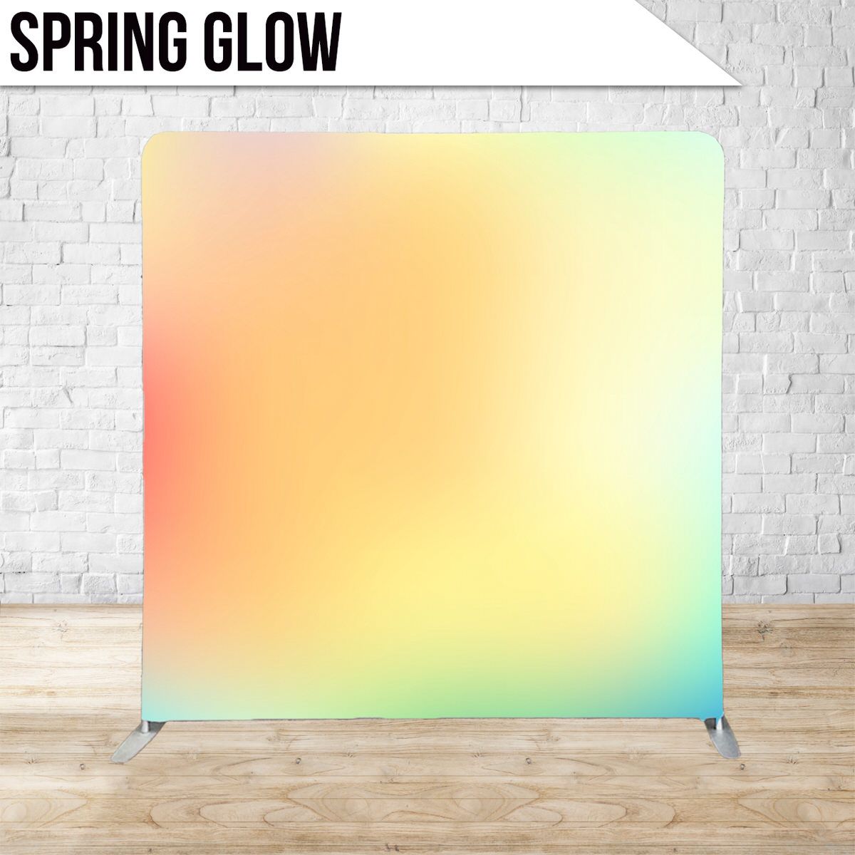 Pastel gradient backdrop with soft orange, yellow and mint green colors against a white brick wall.