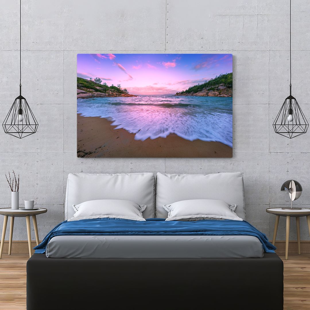 Modern bedroom design with panoramic beach sunset artwork and pendant lighting.