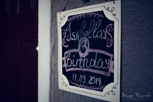 Vintage-style chalkboard birthday sign with decorative frame and handwritten text.