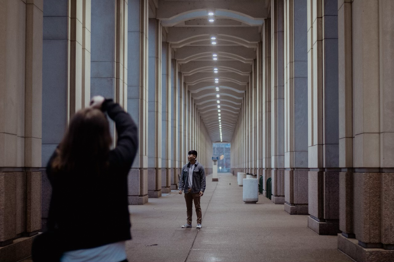 Long symmetric hallway with arched ceiling and columns creating a vanishing point perspective.