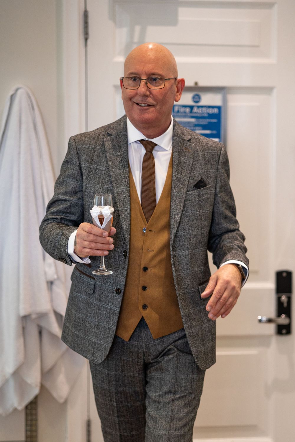 Groom having champagne before his wedding in Brentwood, Essex