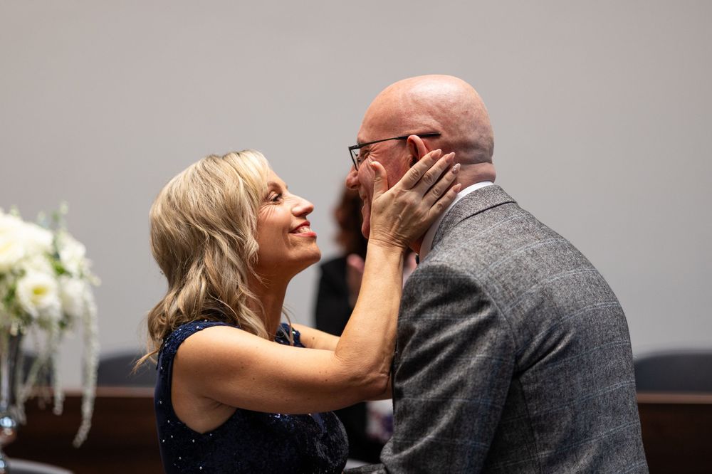Bride and groom first kiss at their ceremony at Brentwood registry office, Essex