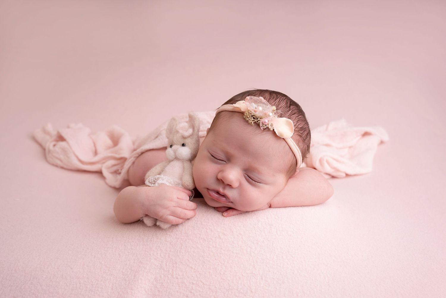 simple posed on baby's hand styled with teddy in a sleepy pose