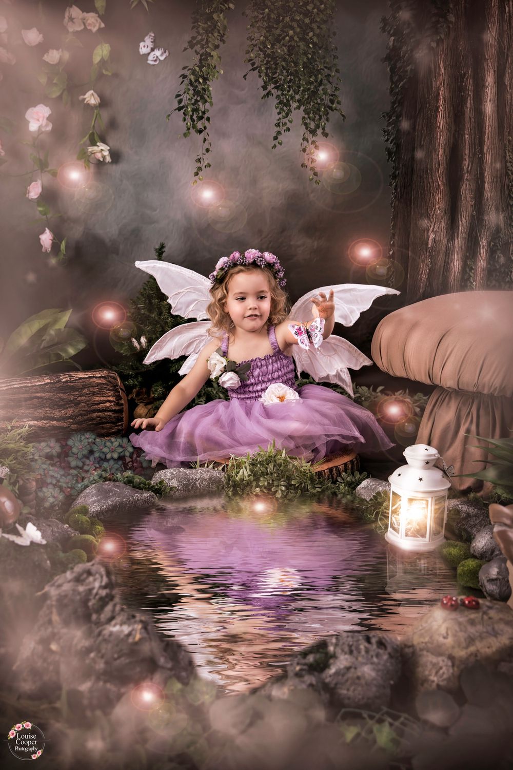 Dreamy fairy scene with wings and lantern beside reflective water.