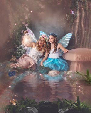Ethereal fairy photoshoot with blue and white dresses in a magical forest setting.