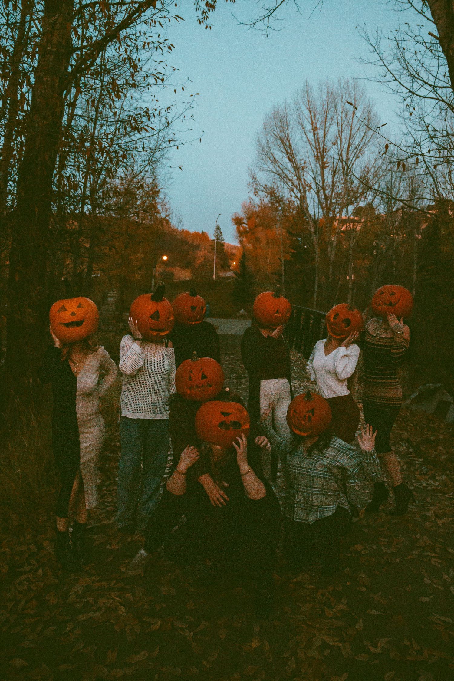 Group photo with carved pumpkins outdoors during Halloween season.