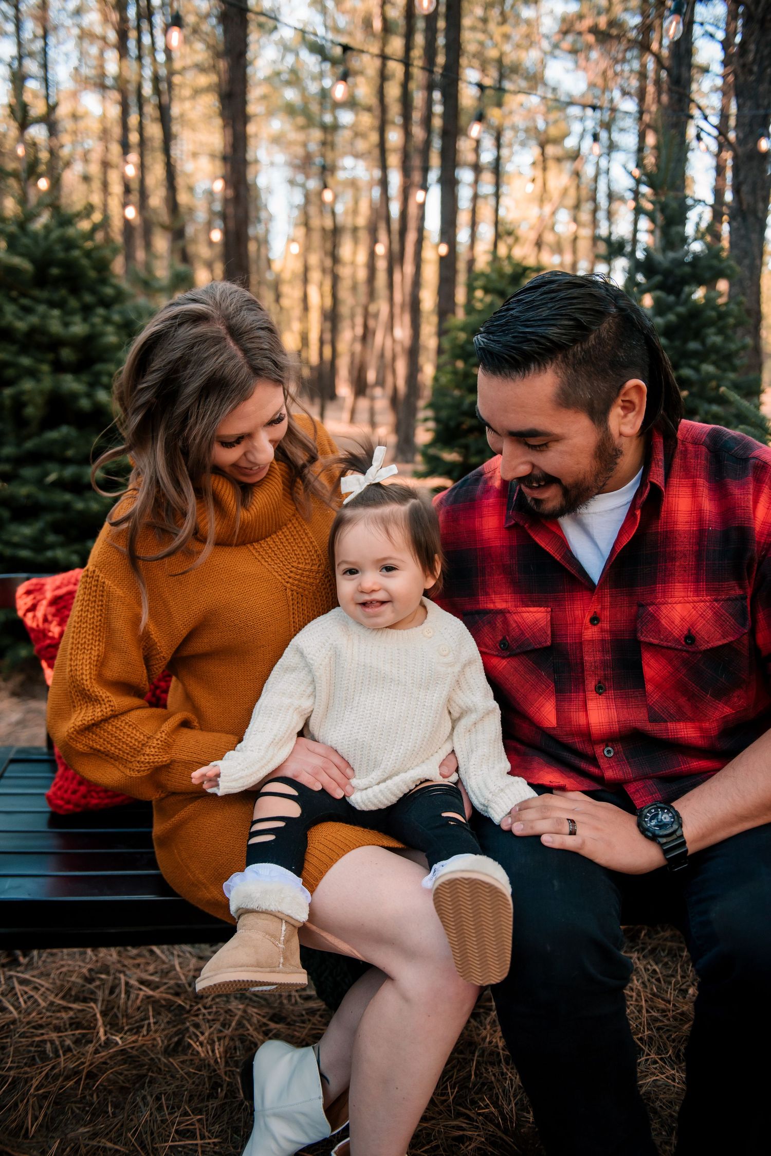 A cozy family moment captured in an autumn forest setting.