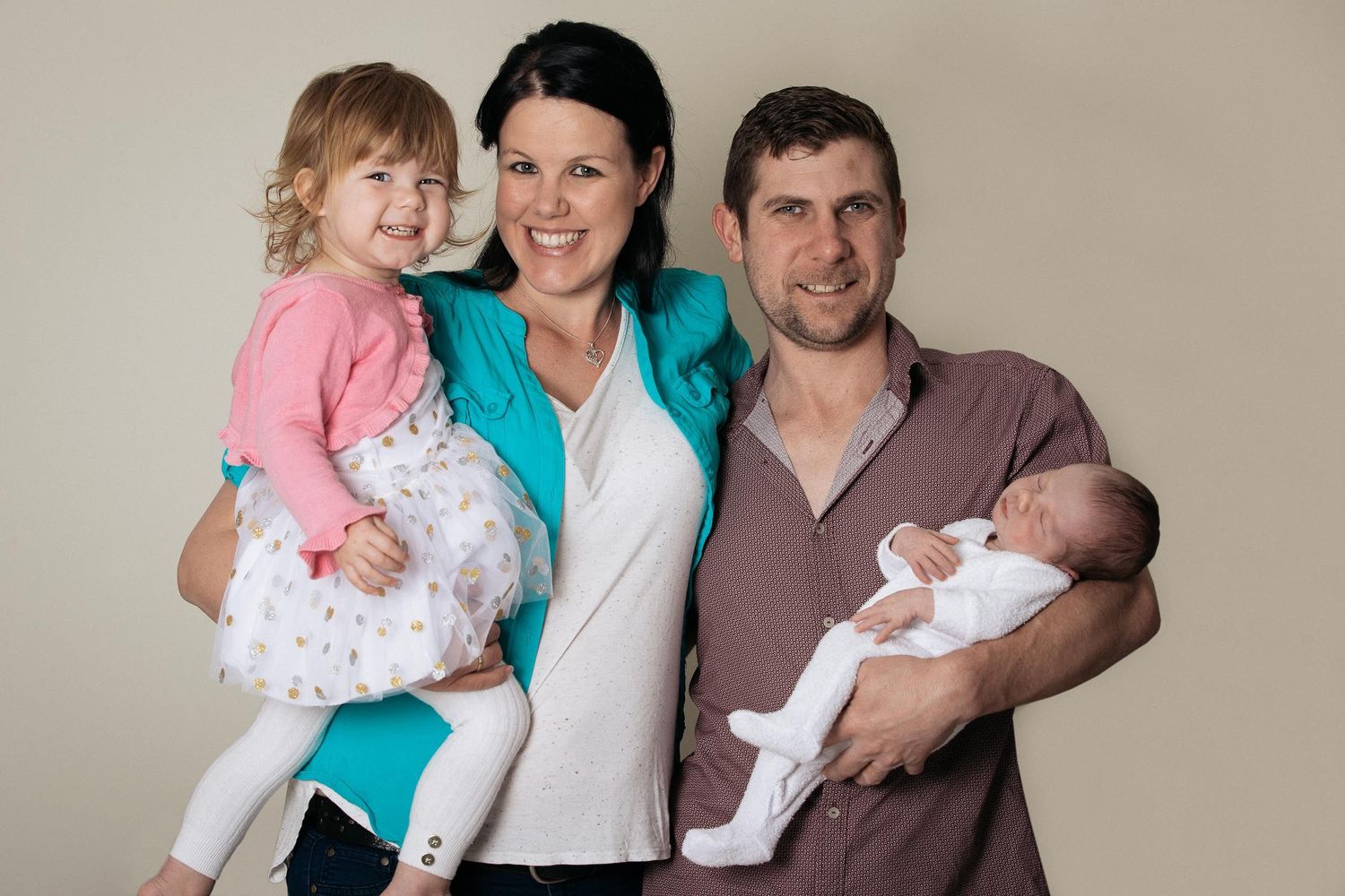young family with toddler and newborn baby