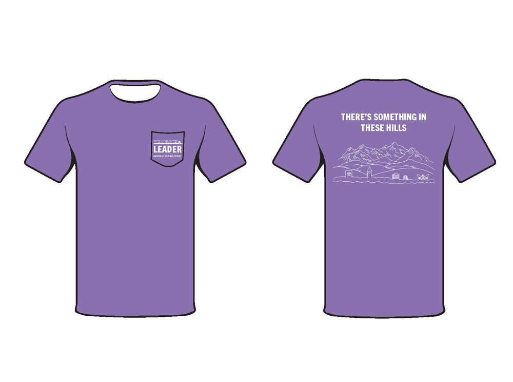 Purple t-shirt design mockup featuring a small pocket on front and mountain scene on back.