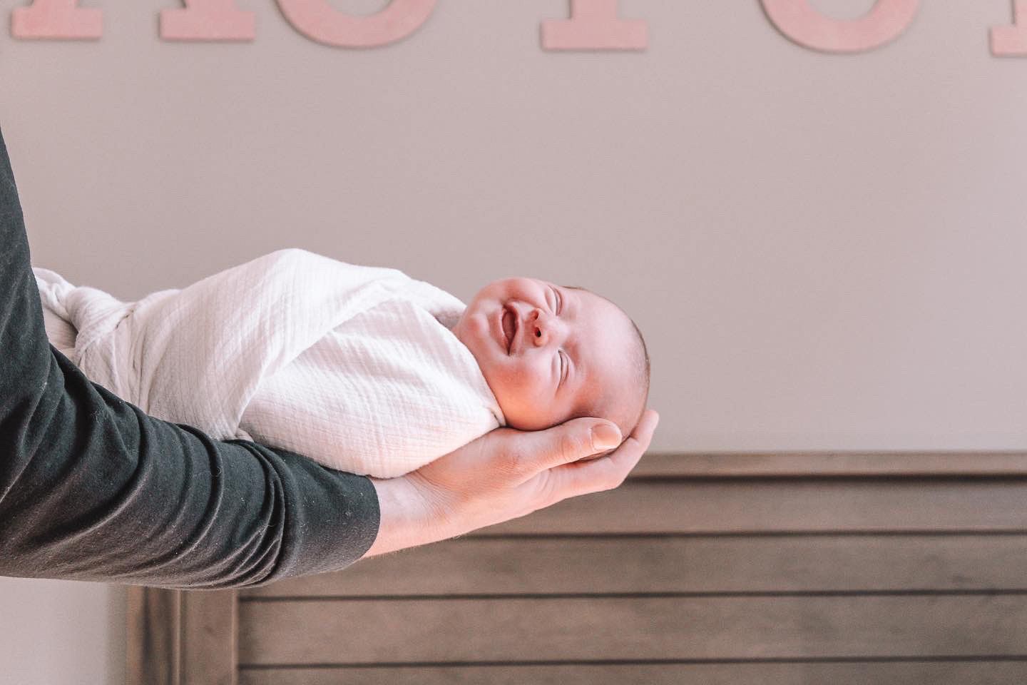 Sequence of a newborn baby being held and positioned during a professional photo session.