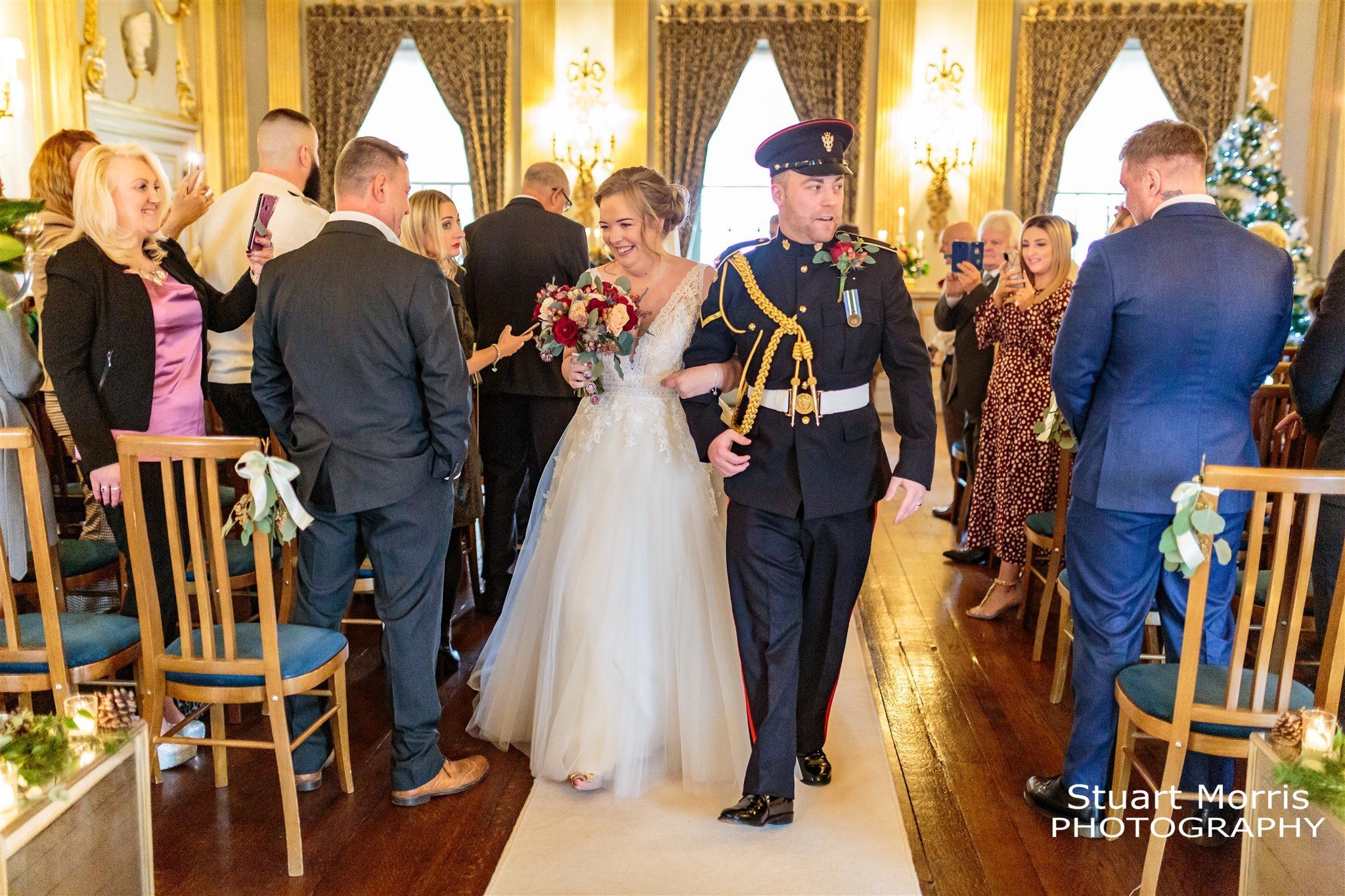 Bride and groom walk back up the aisle as husband and wife at Knowsley hall.