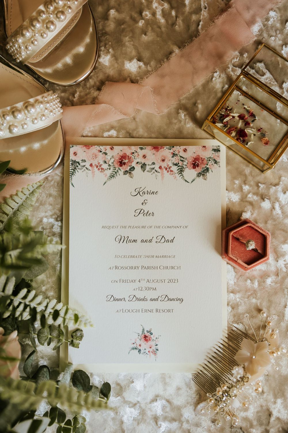 Elegant wedding invitation with floral details and decorative elements.