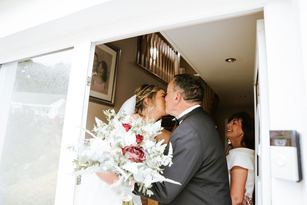Emotional first-look moments captured in a bright indoor setting.