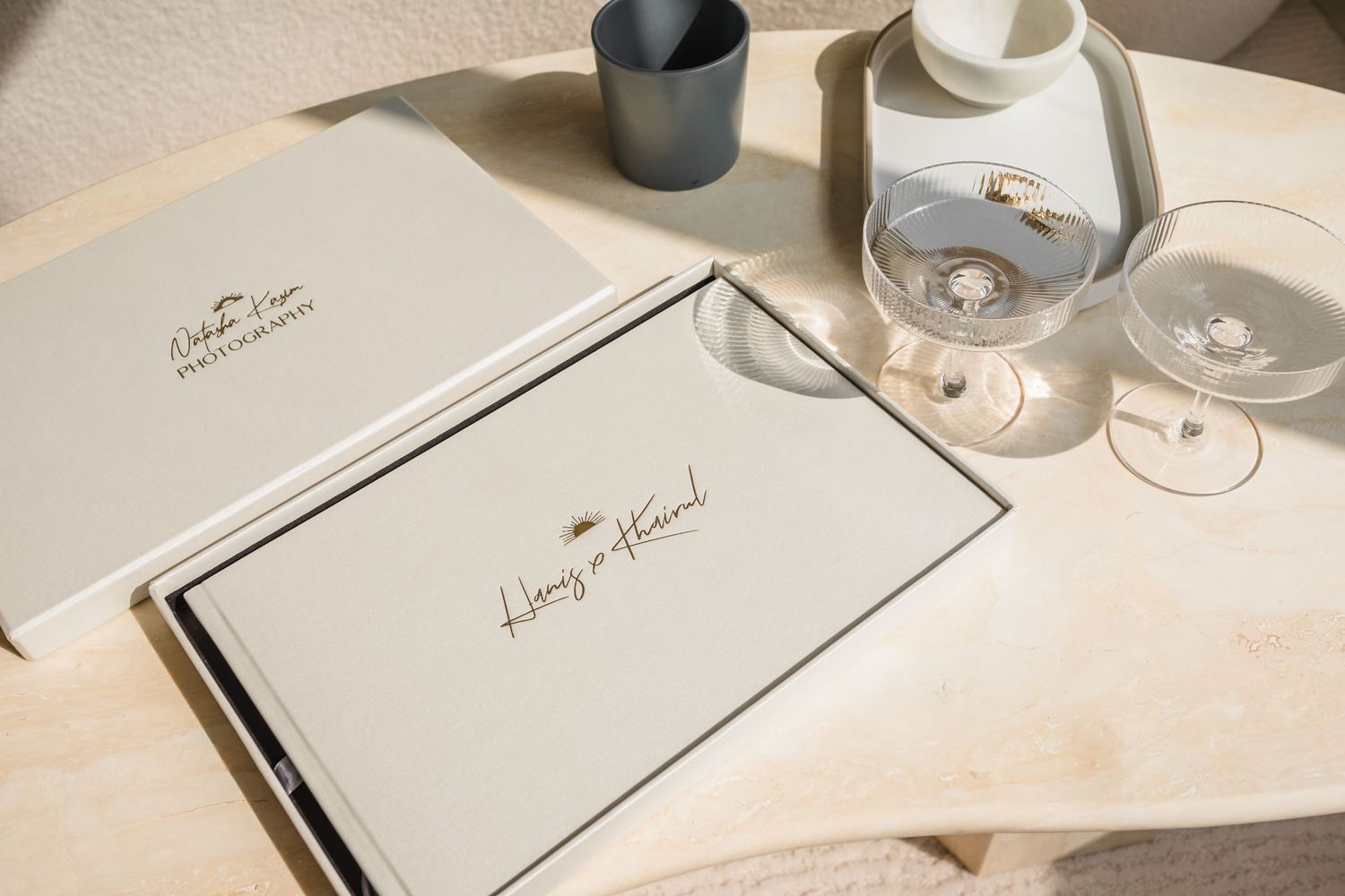 Elegant wedding album layout with black and white design elements in soft lighting.