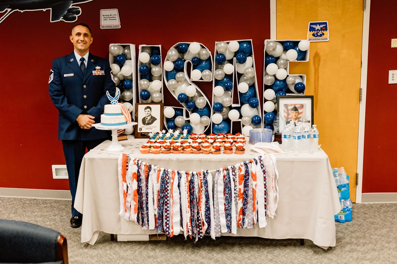 Military celebration display with USA-themed decorations and photo collage.