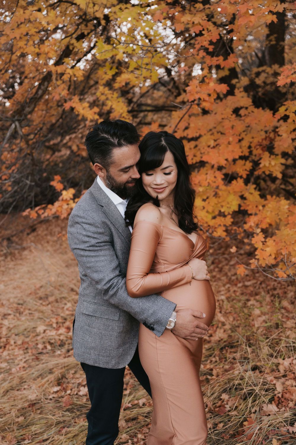 A couple shares their excitement during their maternity photoshoot near Herriman, Utah.