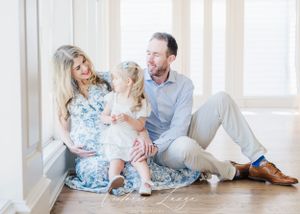 Family sharing tender moment together in bright, airy room.