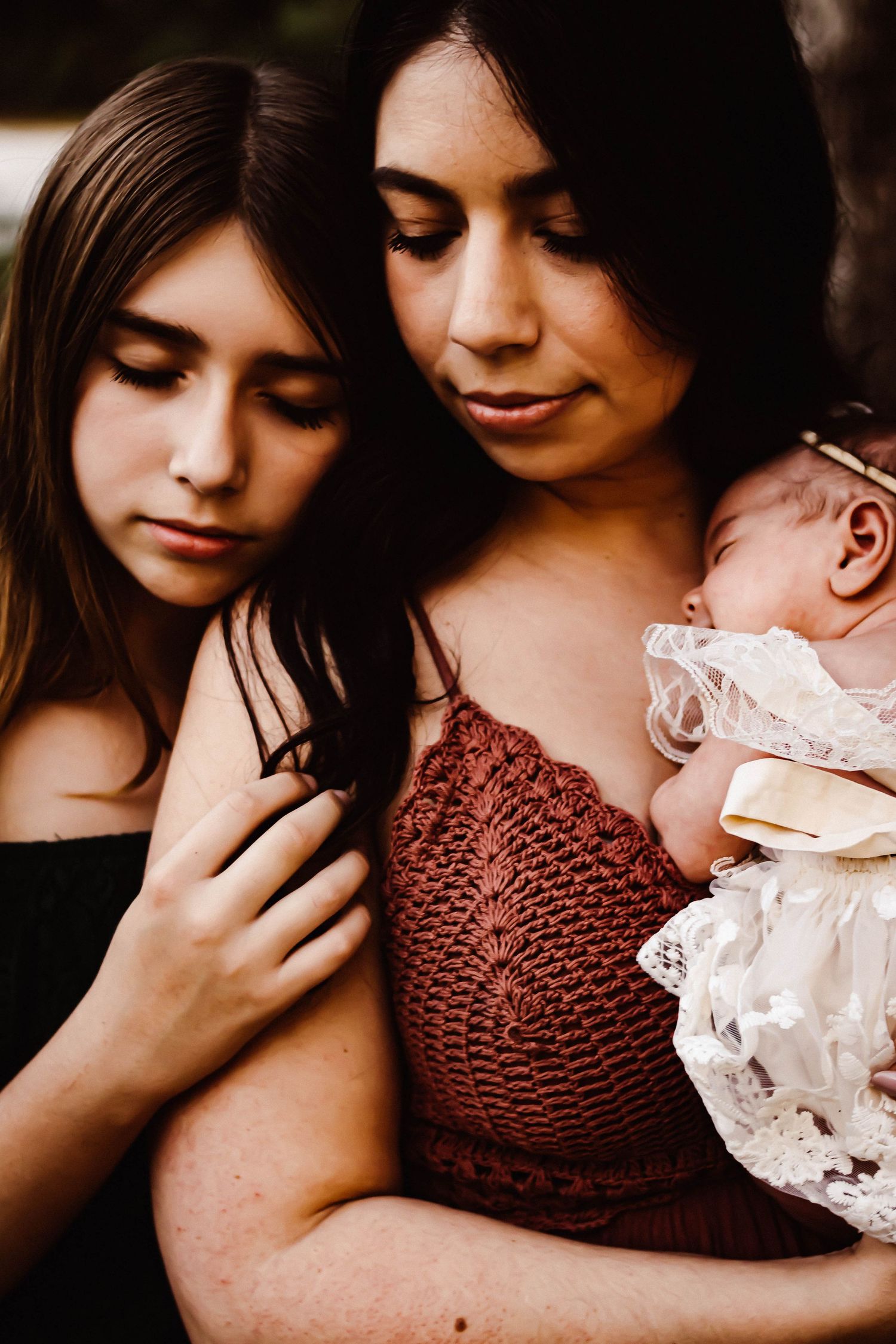 Intimate close-up portrait showing tender embrace in burgundy lace.