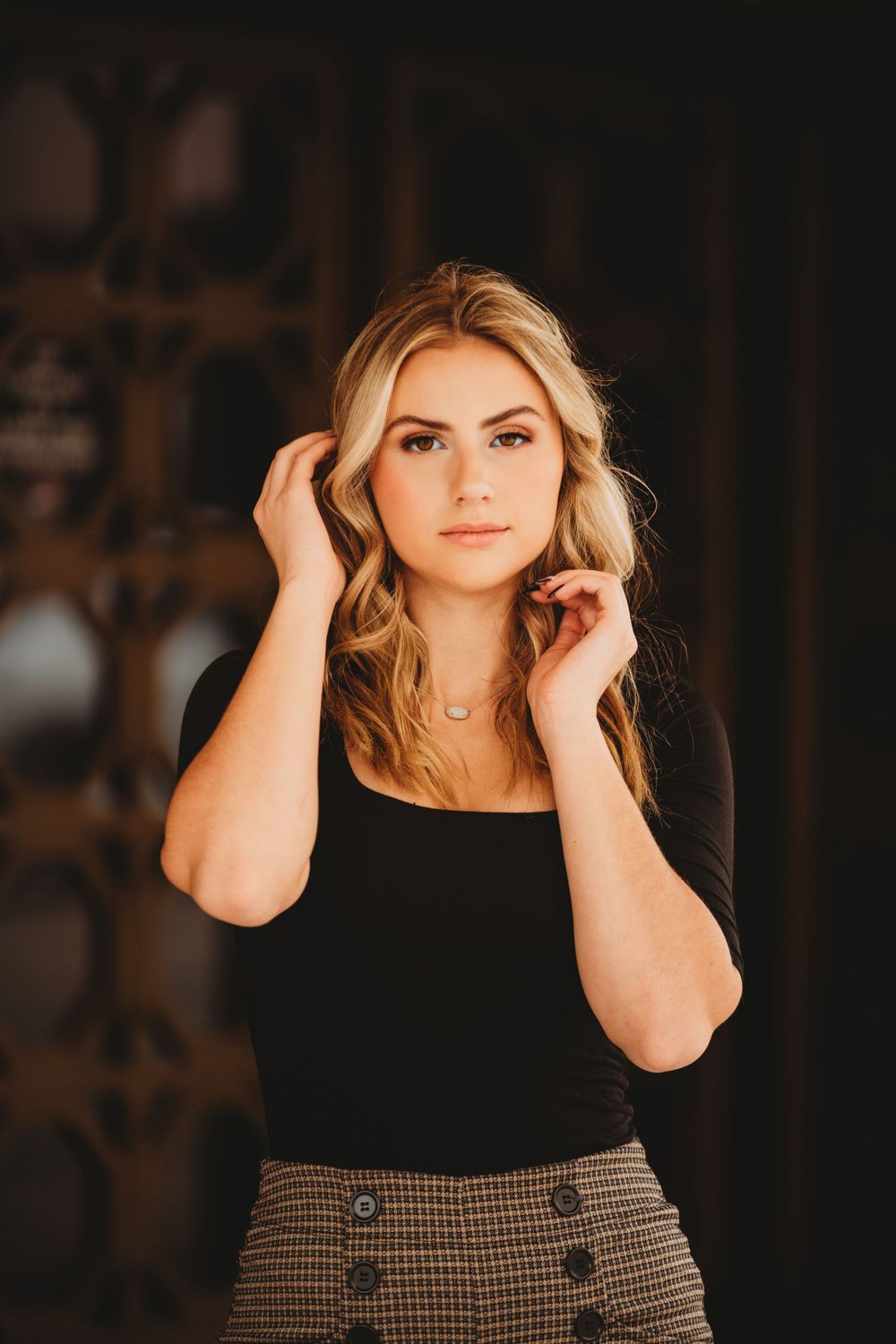 Professional headshot series against dark background with warm lighting.