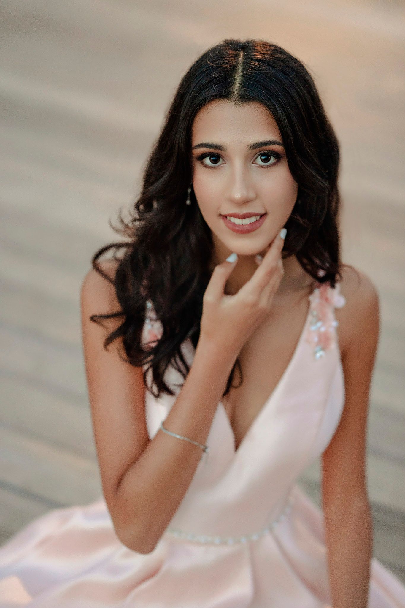 Portrait in soft pink gown with delicate lace details.
