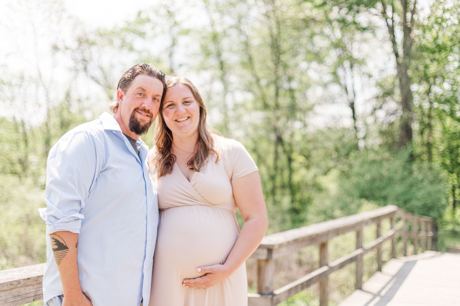 Couple in neutral clothes smiling during a Hudson Valley, NY maternity session in New Paltz, NY