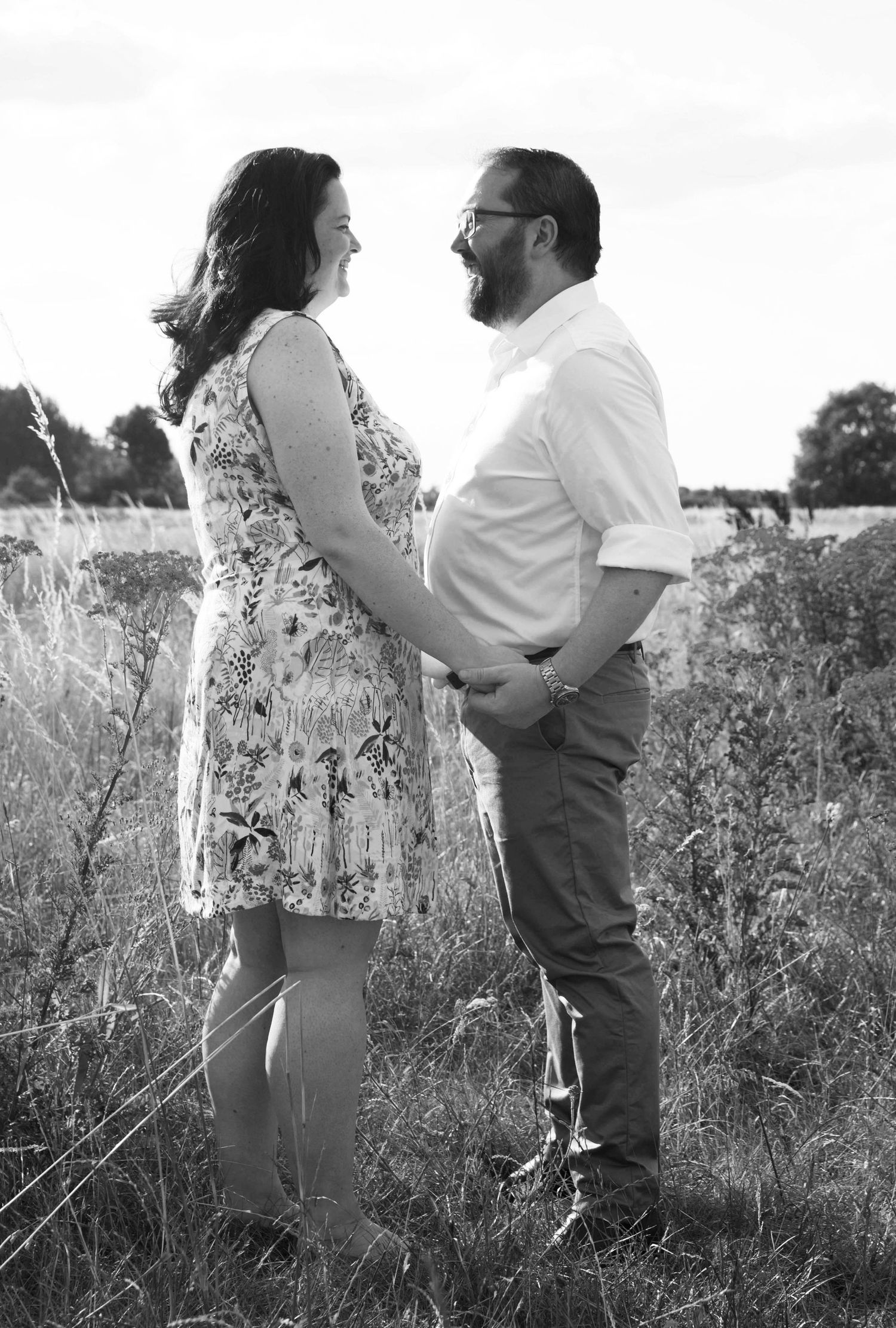 A couple shares an intimate moment together in a field of wildflowers.