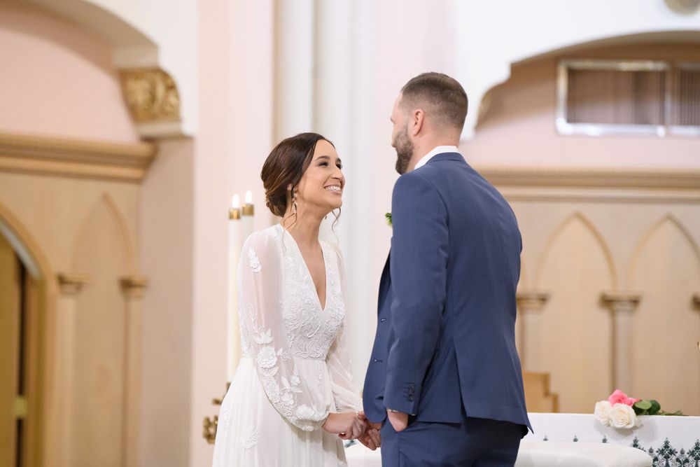 Couple exchanges vows during intimate church wedding ceremony.