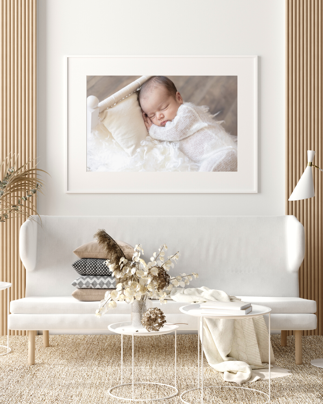 Modern interior with white sofa, wooden slat wall, and framed photograph displayed above minimalist coffee tables and decor.