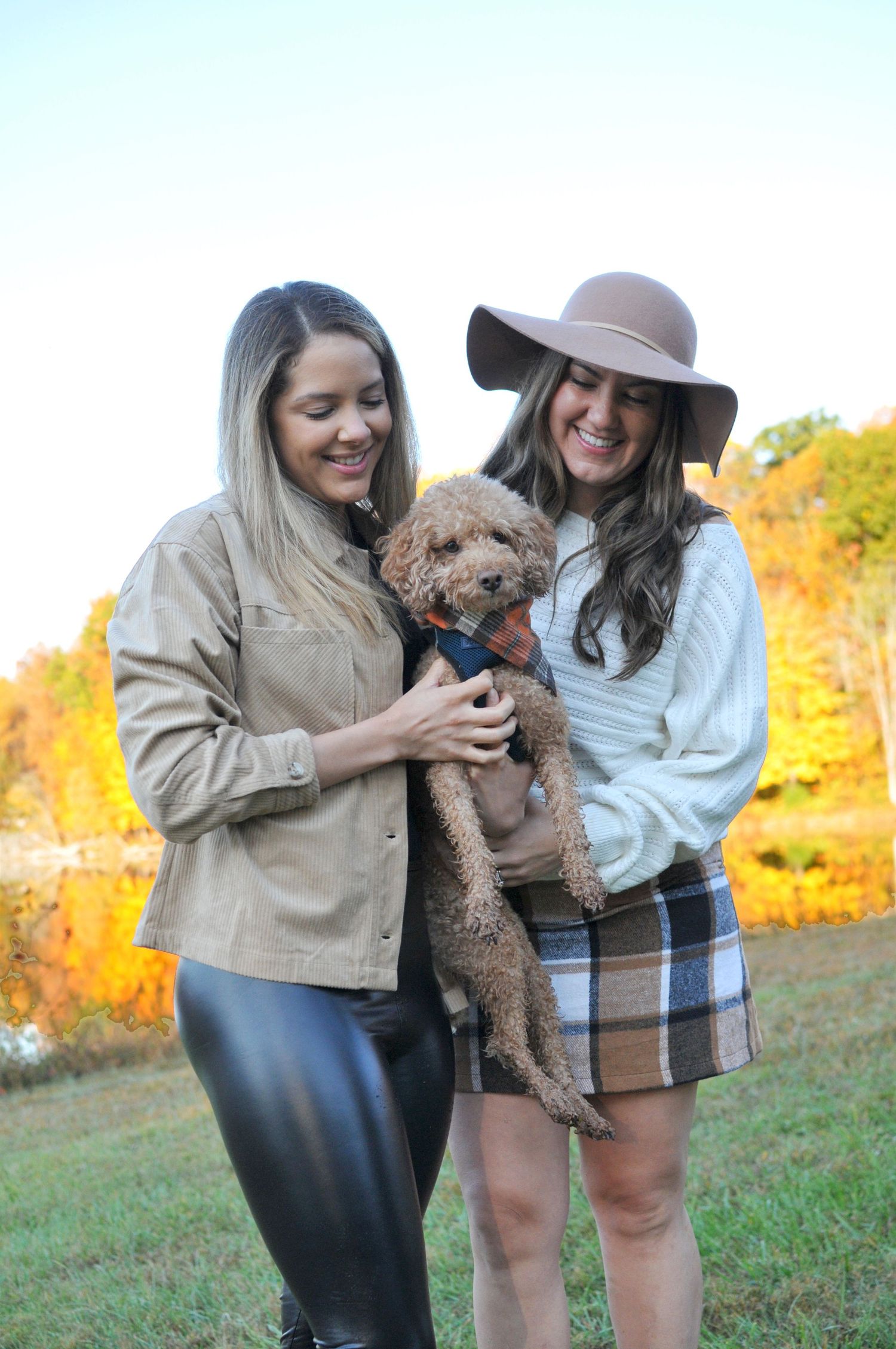 two ladies with puppy dog outside photo