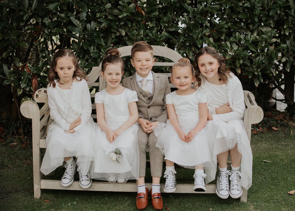 flower girls and Paige boys in the garden at a wedding at St Elizabeth's House in Plympton