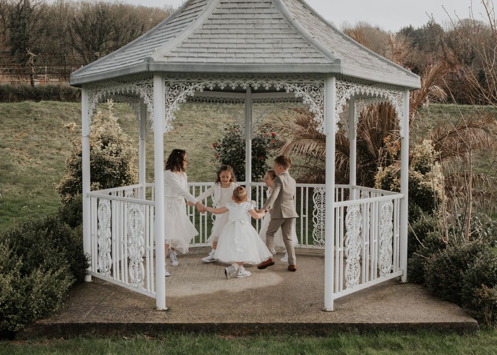 flower girls playing in the garden at a wedding at St Elizabeth's House in Plympton