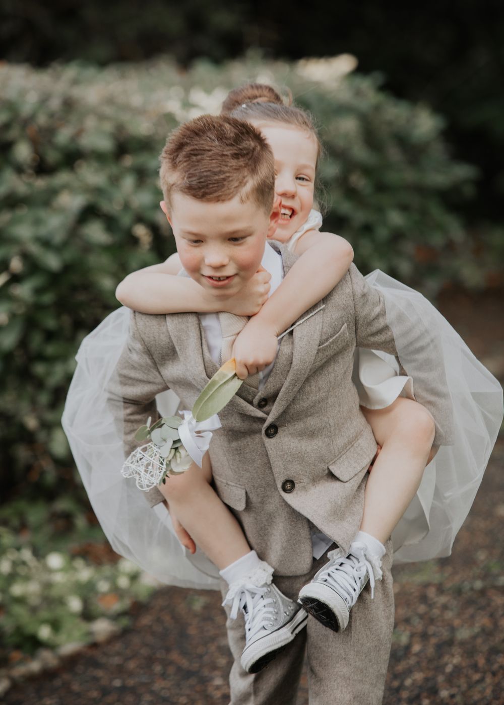 Flower girl and Paige boy play at a wedding in Cornwall