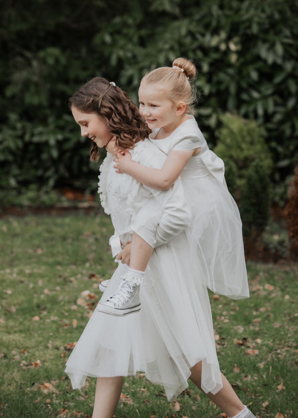 flower girls walking through the garden at a wedding at St Elizabeth's House in Plympton