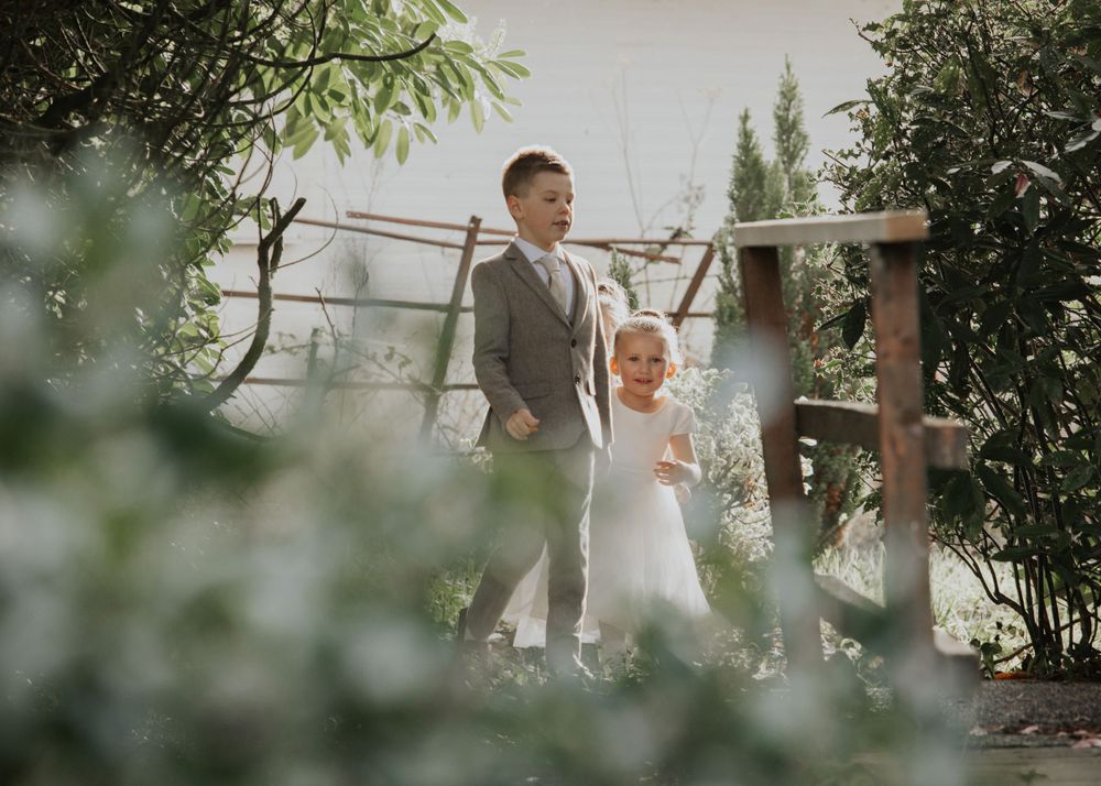flower girls and Paige boys in the garden at a wedding at St Elizabeth's House in Plympton