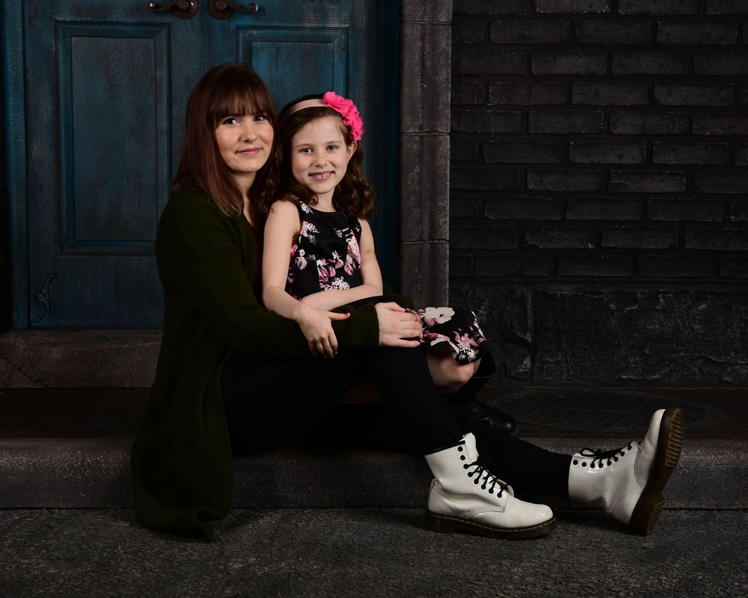 Studio portrait session with dark background and dramatic lighting.