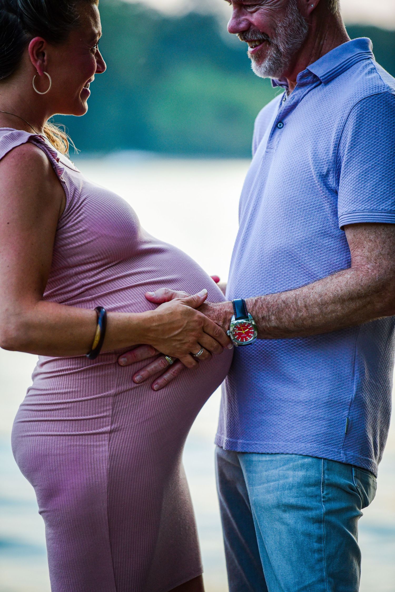 Maternity photo sequence showing a couple embracing by a lake with willow trees in the background.
