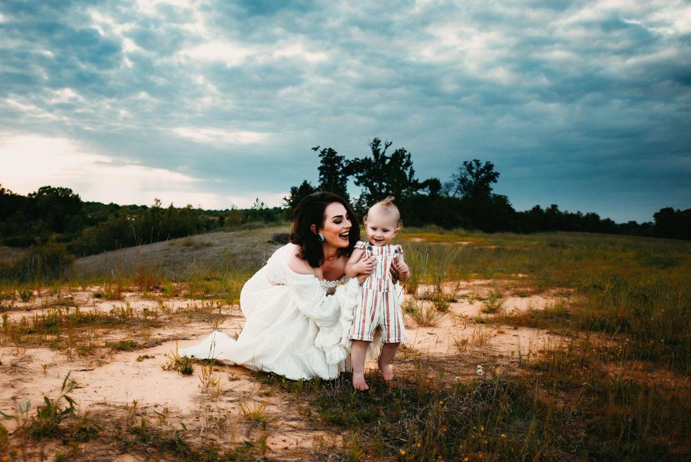 Candid family moments captured in a natural desert setting with moody sky.