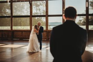 Sun-filled wedding venue with large windows and natural light streaming in.