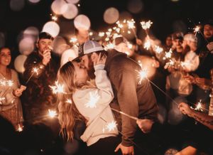 A magical sparkler moment at a nighttime wedding celebration.