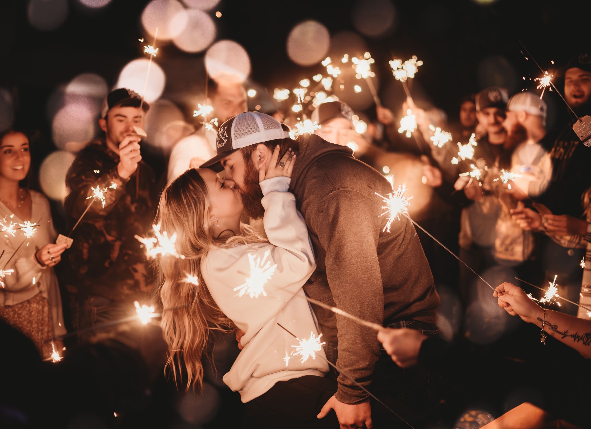 A magical sparkler moment at a nighttime wedding celebration.