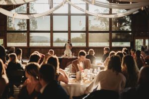 Wedding reception venue with draped fabric ceiling and ambient lighting creating a romantic atmosphere.